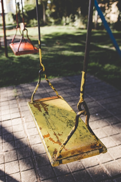 Premium Photo | An empty swing set at a playground. swing alone in a ...