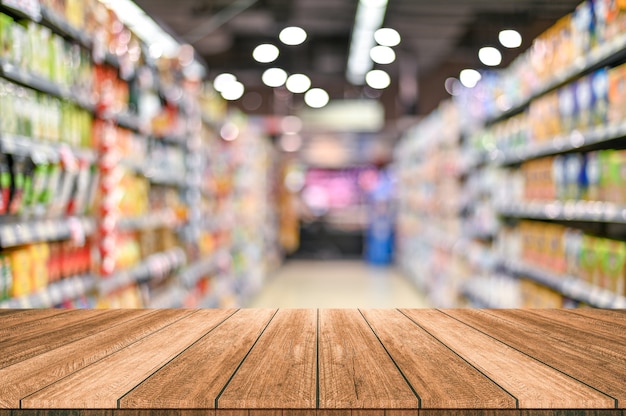 Empty top wooden table with supermarket blur background Premium Photo