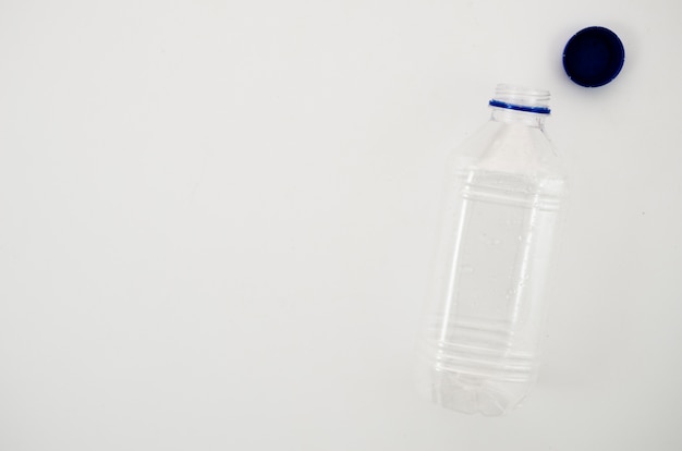 Empty transparent water bottle with it's cap isolated on white