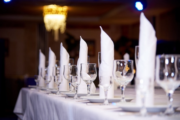Empty wine glass on the banquet table.table setting for a banquet or dinner party. Premium Photo