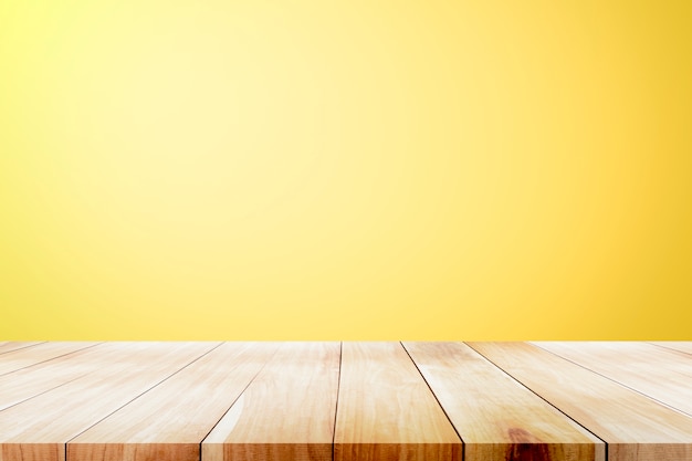 Premium Photo | Empty wooden deck table over yellow wallpaper background.