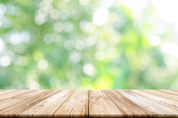 Premium Photo | Empty wooden table top with blurred green garden ...