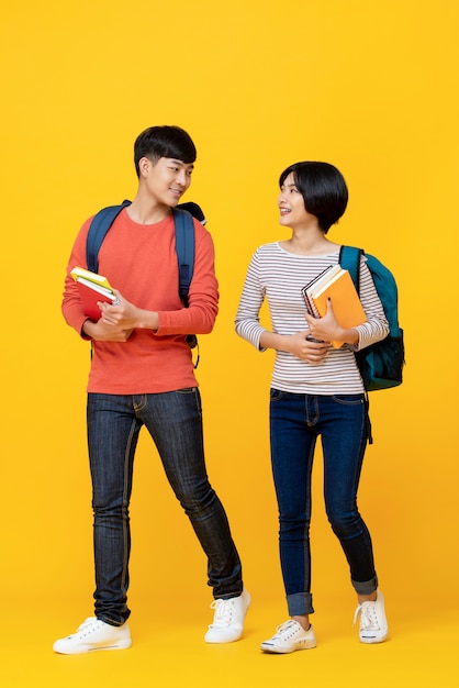 Energetic asian students walking and talking together Premium Photo