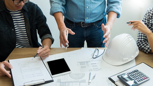 Engineer discussing meeting working on blueprint project architectural at construction site. Premium Photo