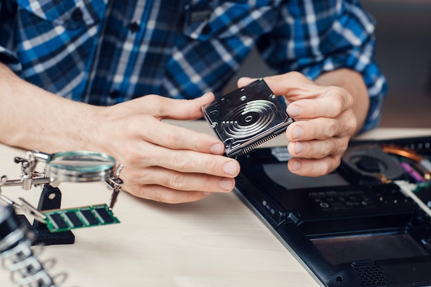 Premium Photo | Engineer Holding Winchester Disk In Hands