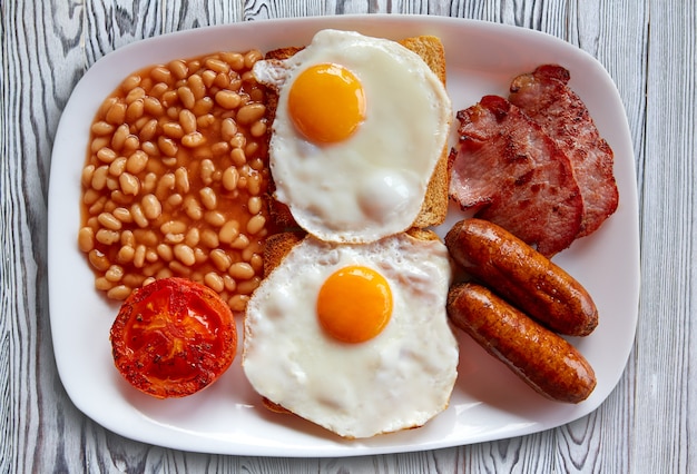 Premium Photo | English breakfast with two eggs sausage beans