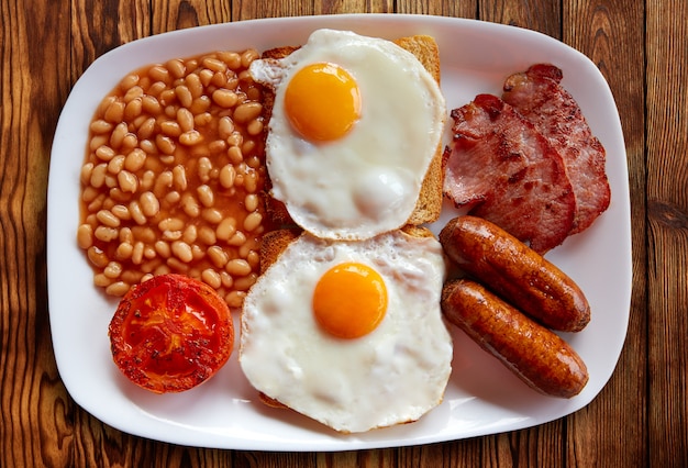 Premium Photo | English breakfast with two eggs sausage beans