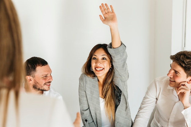 Free Photo | Enthusiastic young woman with raised hand