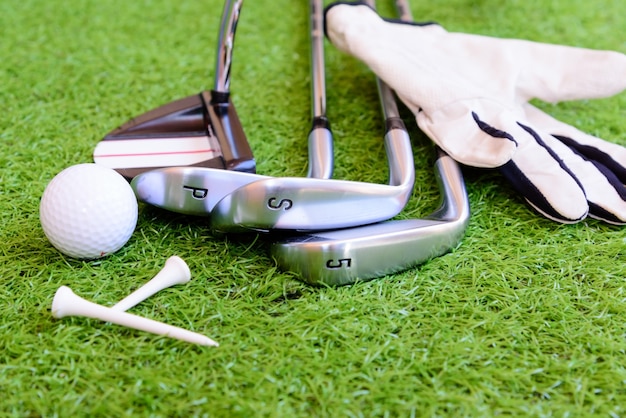 Premium Photo | Equipment for playing golf on green grass background.