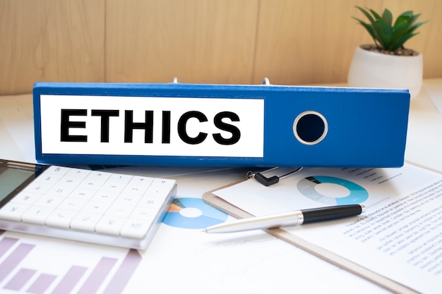 Premium Photo | Ethics words on labels with document binders