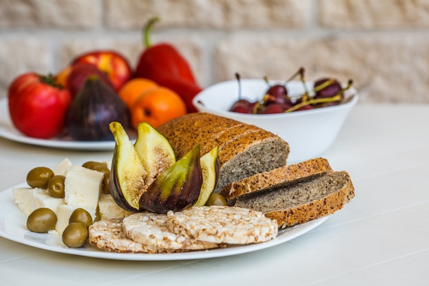 European healthy vegetarian food on a white table on the balcony Premium Photo