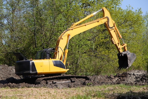 Premium Photo | Excavator Before Working Day Of Digging Against Forest