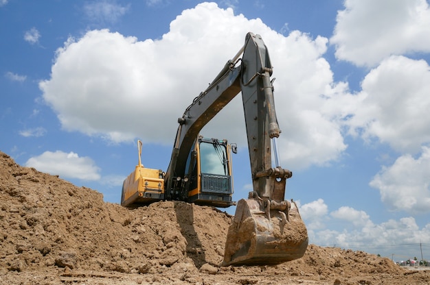 Premium Photo | Excavator blue sky heavy machine construction site soil ...