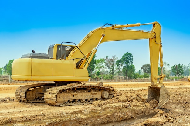 Premium Photo | Excavator is digging the soil for clearing site ...