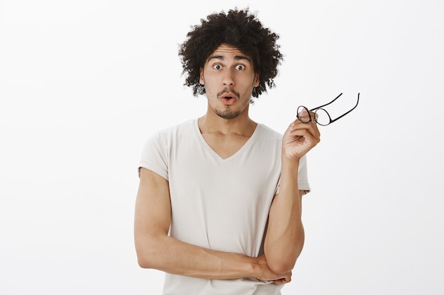 Free Photo Excited Attractive Man Take Off Glasses And Looking Amazed