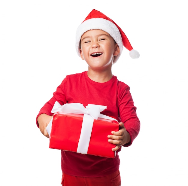 Excited child with his christmas gift Photo Free Download