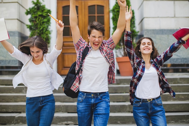 Excited students leaving university Photo | Free Download