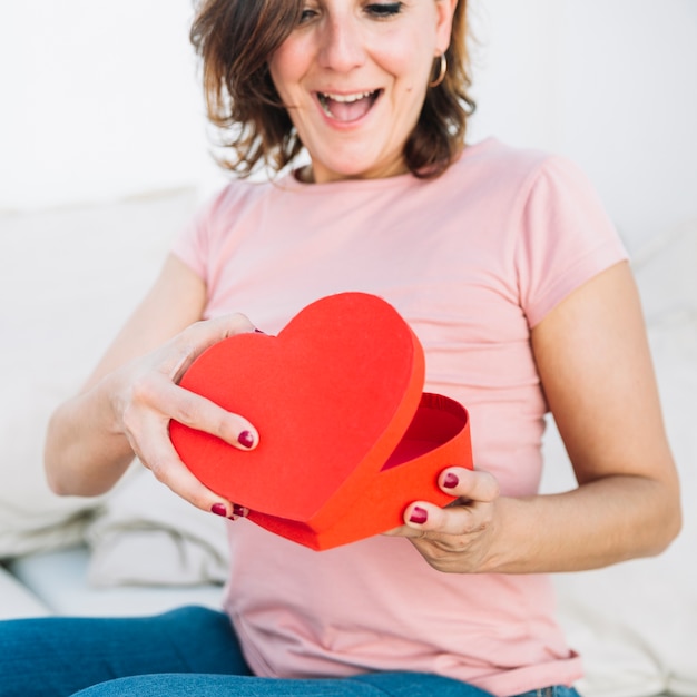 Free Photo | Excited woman opening heart-shaped box