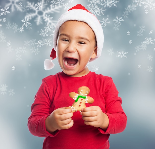 Excited young boy celebrating christmas with a gingerbread Photo | Free ...