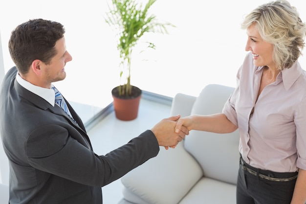 Premium Photo | Executives shaking hands in the living room