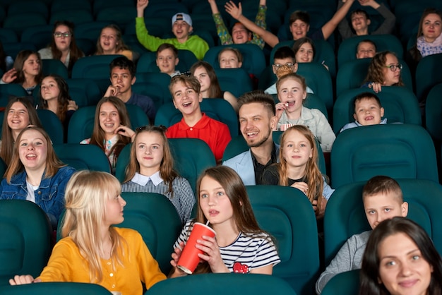 Premium Photo | Exited children sitting in the cinema.