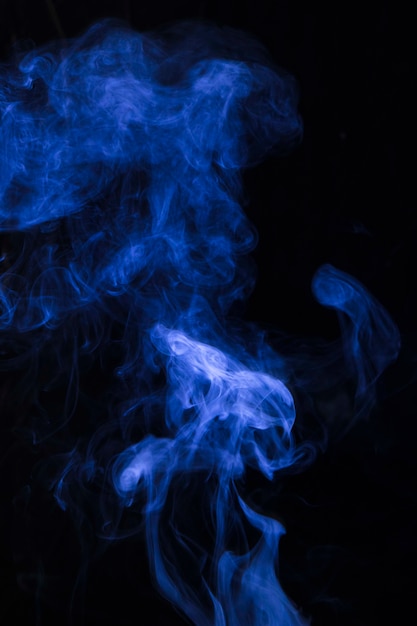 Free Photo | Explosion of blue smoke against black background