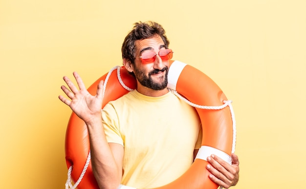 Premium Photo | Expressive crazy man smiling happily, waving hand ...