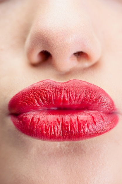 Premium Photo | Extreme close up on gorgeous red lips kissing at camera