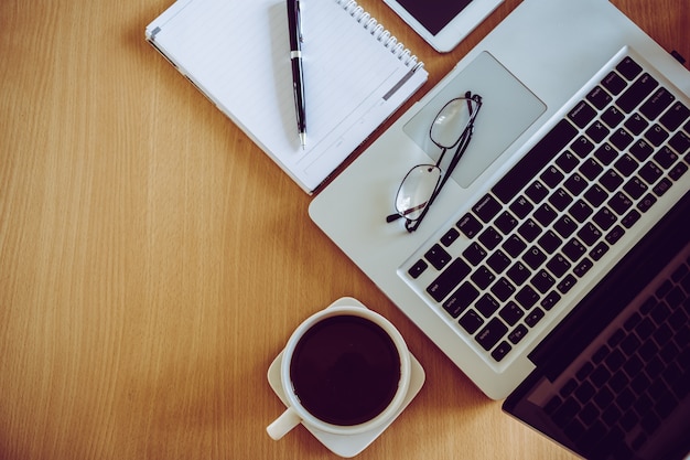 Download Eyeglasses on laptop keyboard pen on notebook with coffee ...