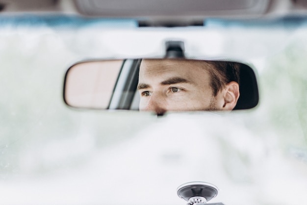 Premium Photo | Eyes in the rear view mirror