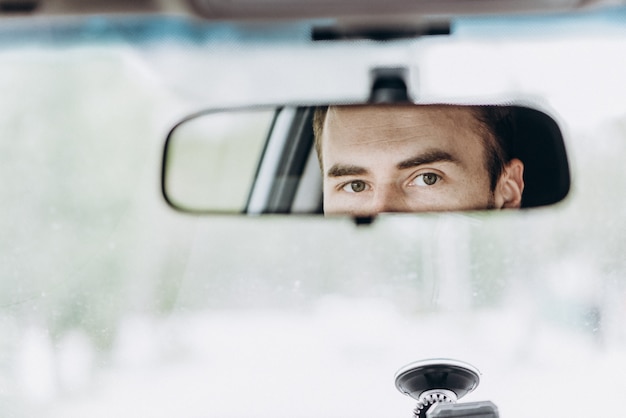 Premium Photo | Eyes in the rear view mirror