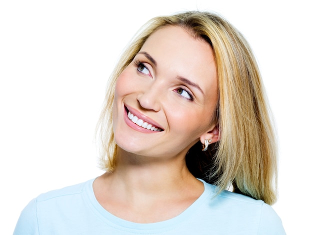 Free Photo Face Of A Smiling Pensive Woman Looking Up Isolated On White