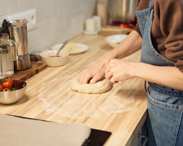 Premium Photo Faceless Woman Kneading Dough On Kitchen Table At Home Apartment Flour Scales Bowls Digital Tablet With Recipes On Table Homemade Food