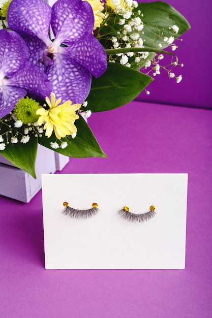 Premium Photo False Eyelashes And Purple Flowers Composition Beauty