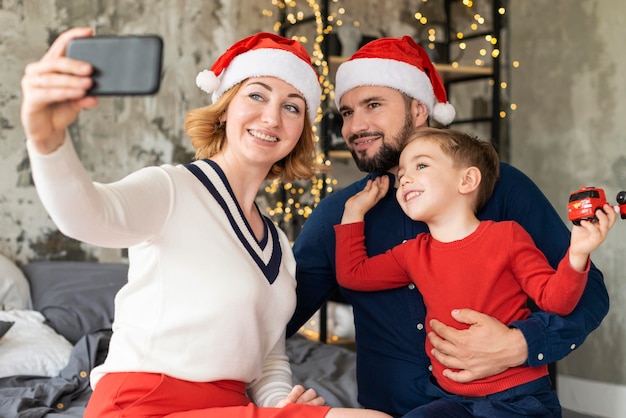 Premium Photo | Family celebrating christmas together with a selfie