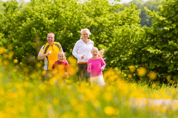 Premium Photo | Family jogging in the meadow for fitness