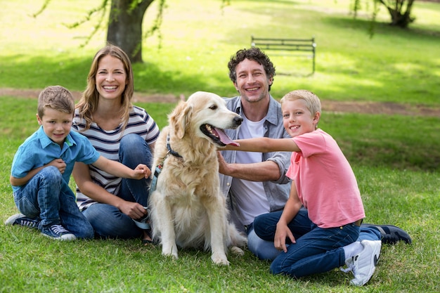 Family with dog in the park Photo | Premium Download