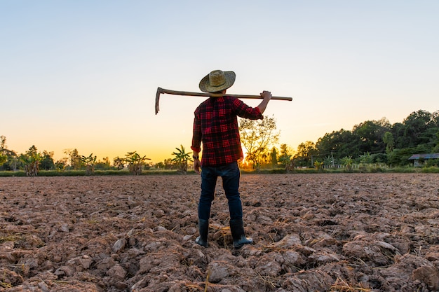 Premium Photo | Farmer Working On Field At Sunset Outdoor