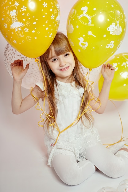 Fashion girl child celebration with balloons Premium Photo