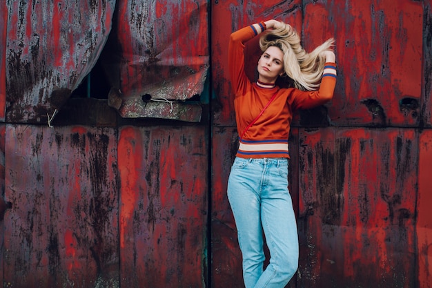 Premium Photo | Fashion portrait of cute blonde girl posing over rusty ...