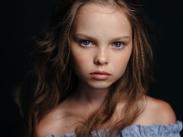 Premium Photo Fashionable Girl In A Sundress On A Dark Background Curly Hair Blue Eyes