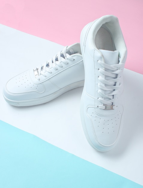 Premium Photo | Fashionable white sneakers on a colored pastel table ...