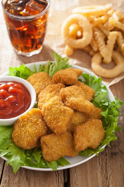 Premium Photo | Fast food chicken nuggets with ketchup, french fries, cola