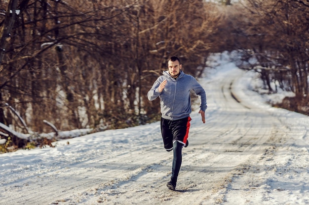 Premium Photo | Fast runner running on snowy path in nature at sunny ...