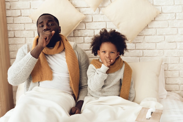 premium-photo-father-and-daughter-coughing-sitting-on-bed-at-home