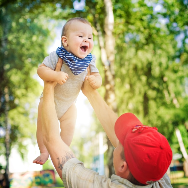 premium-photo-father-fun-happy-son-throws-up-it-s-sunny