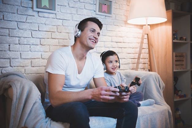 father and son playing video games