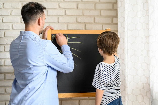 Free Photo | Father and son drawing together