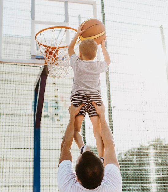 Premium Photo | Father and son playing basketball