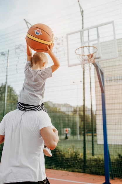 Free Photo | Father and son playing basketball